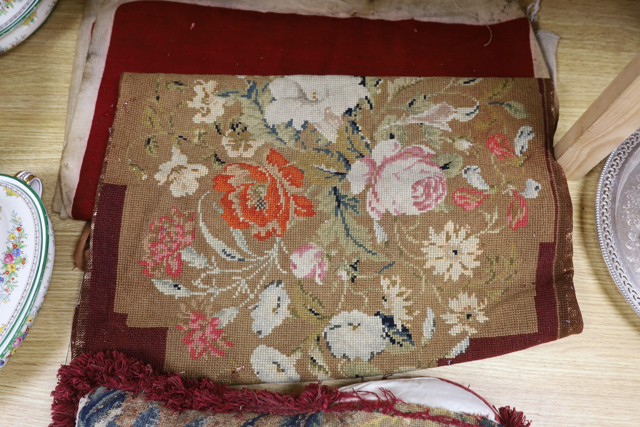 A French 18th century woolwork cushion, 2 chair covers, another panel, a tasselled brocade cushion and an Indian metallic brocaded patchworked cover